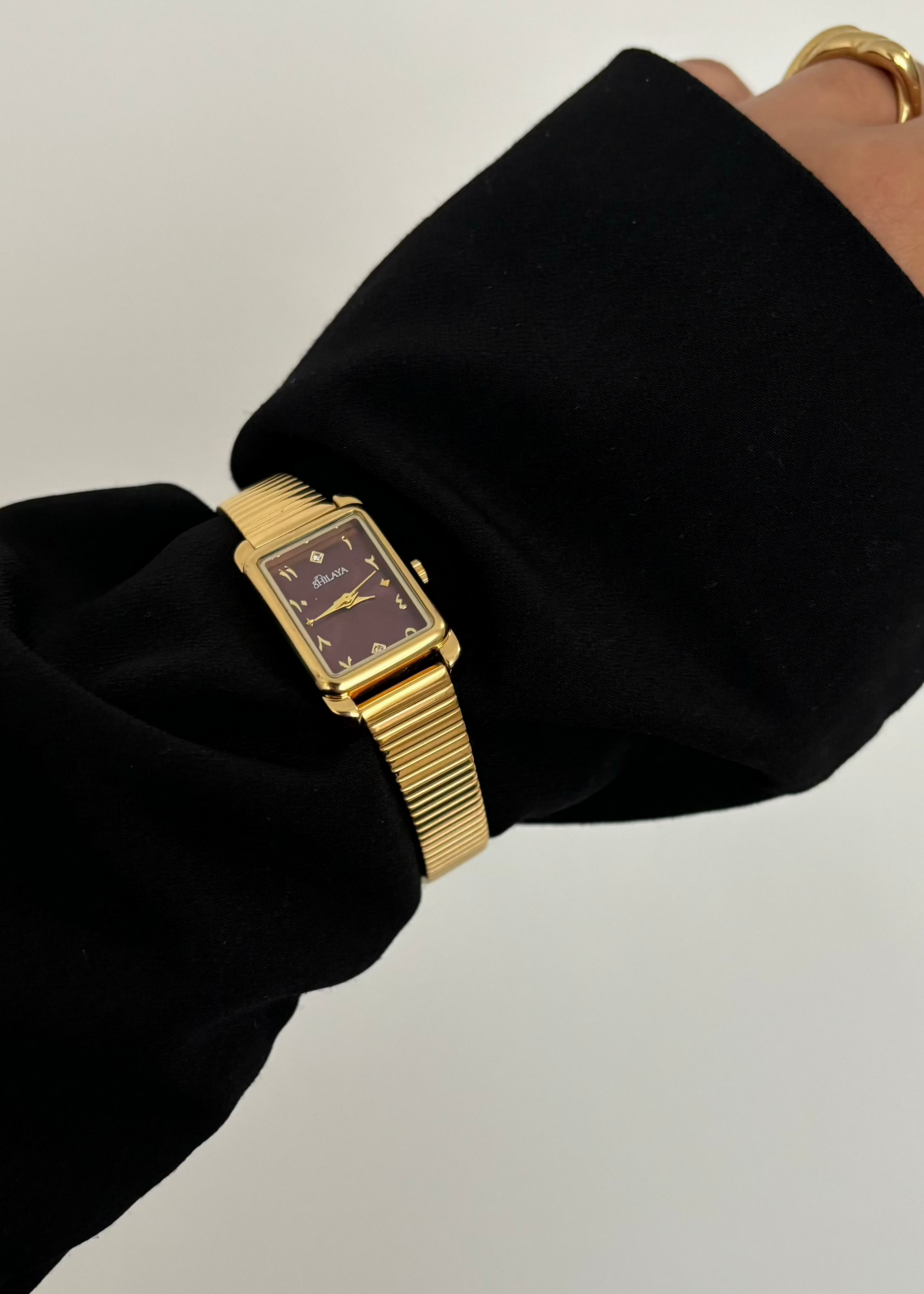THE MIDNIGHT GOLD WATCH WITH ARABIC NUMERALS